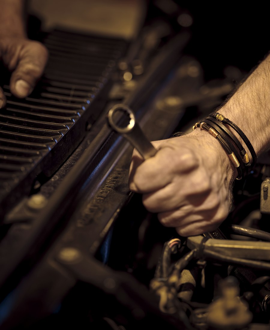 Mechanic working on a car engine with a wrench