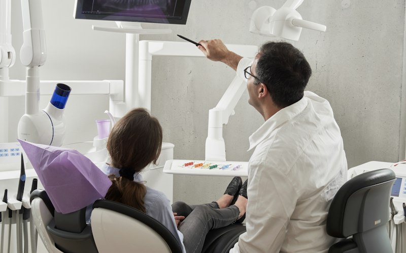 Dentist reviewing a dental X-ray with a patient
