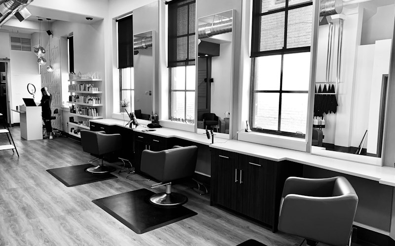 Modern salon styling stations with chairs and mirrors
